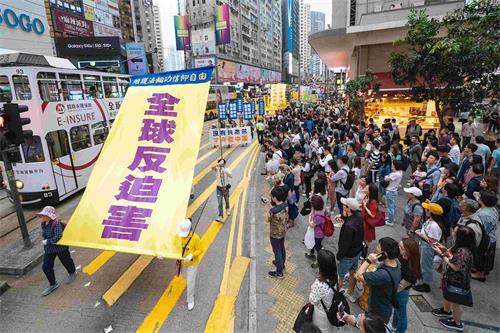 '图11：游行队伍展示大型幡旗，呼吁全球反迫害。'